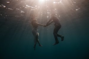 Foto por debajo de Pareja sumergida en el agua, UCDM La canción olvidada